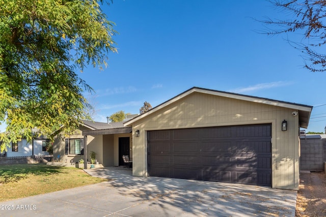 single story home with a garage and a front lawn