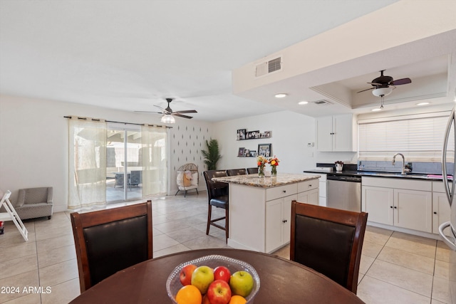 kitchen with dishwasher, a kitchen island, white cabinetry, and sink