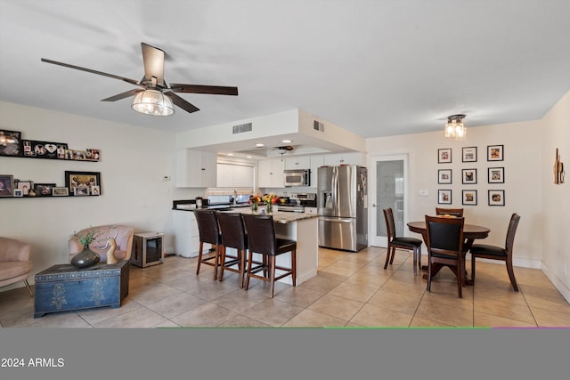 tiled dining area featuring ceiling fan