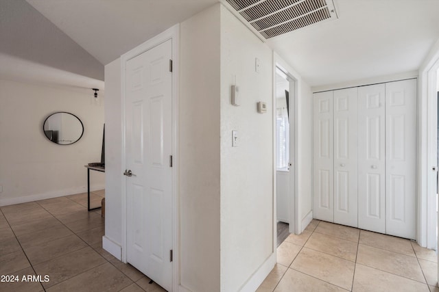 hallway featuring light tile patterned flooring