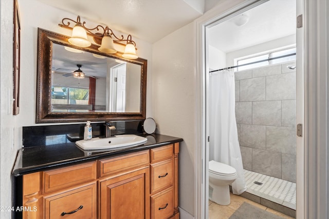 bathroom with vanity, tile patterned floors, ceiling fan, toilet, and walk in shower