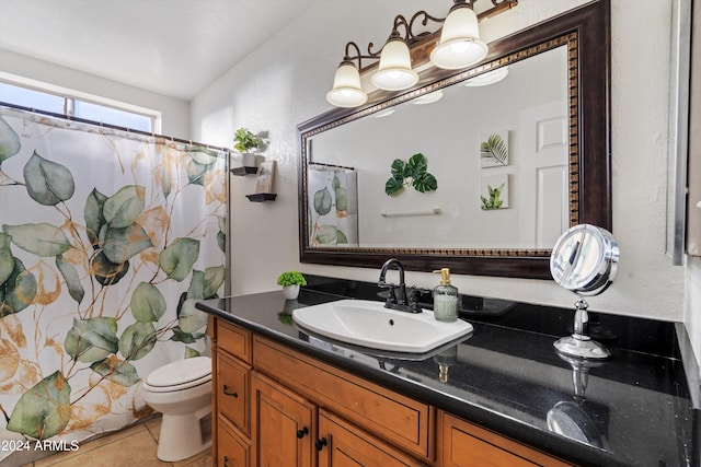 bathroom featuring tile patterned floors, vanity, toilet, and walk in shower