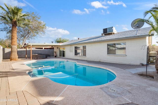 view of pool with a patio and central AC unit