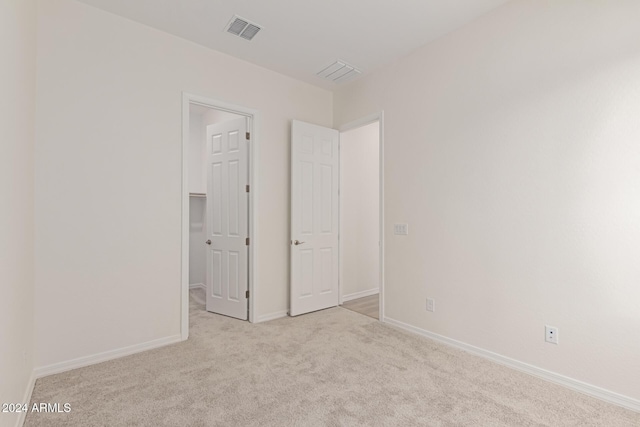 unfurnished bedroom featuring light colored carpet