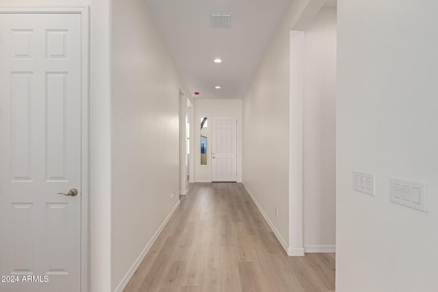 hall with light hardwood / wood-style flooring