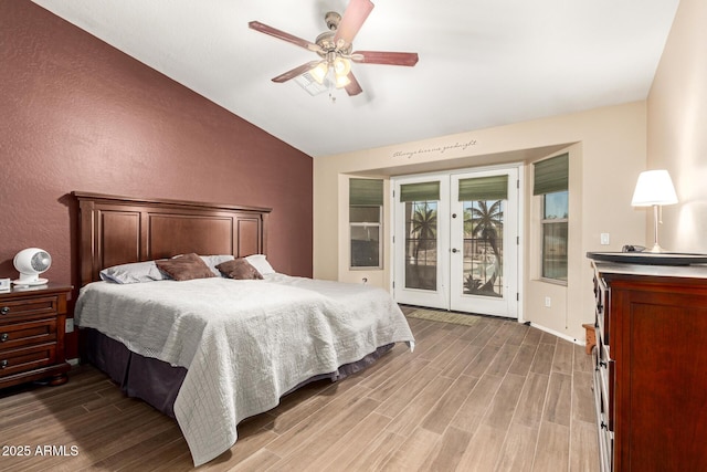 bedroom with a ceiling fan, wood finished floors, lofted ceiling, access to exterior, and french doors