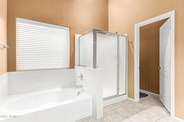 full bath with a garden tub, a shower stall, and tile patterned flooring