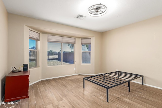 interior space with wood finished floors, baseboards, and a healthy amount of sunlight