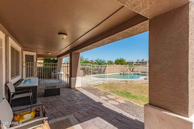 view of patio with fence and a fenced in pool