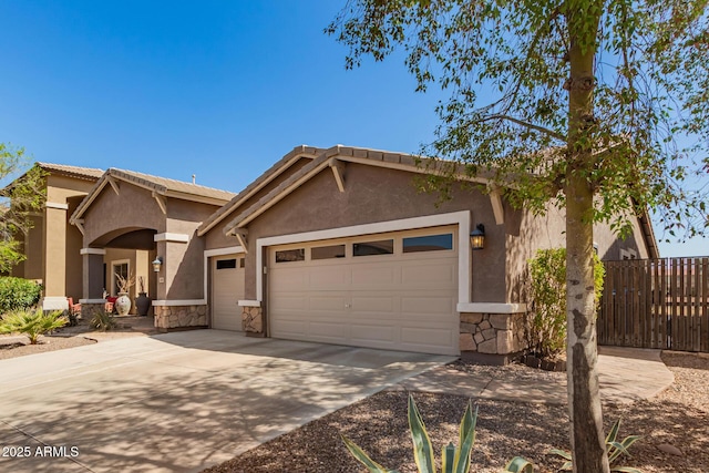 view of front of home featuring stone siding, stucco siding, an attached garage, and concrete driveway