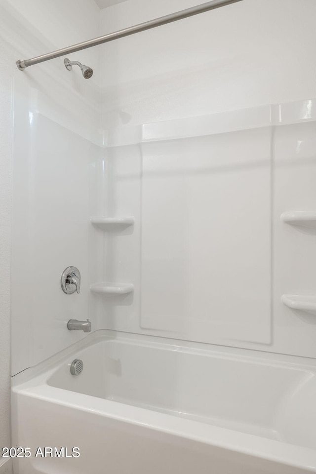 bathroom with shower / washtub combination