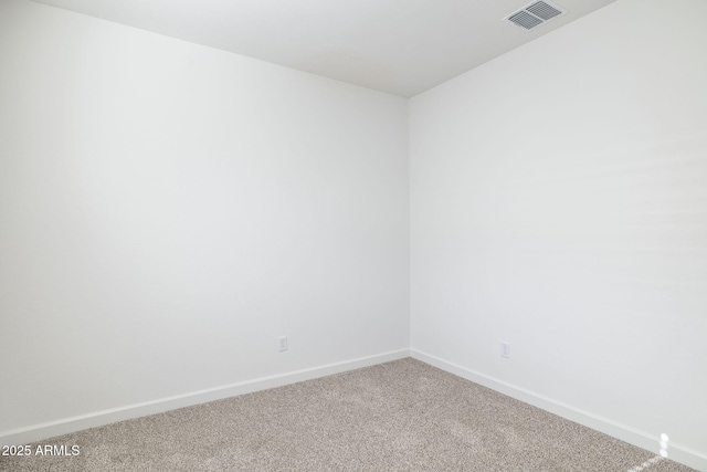 carpeted empty room with baseboards and visible vents