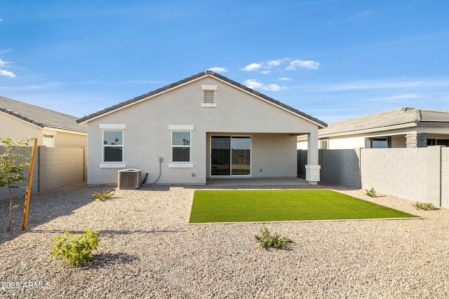 rear view of house with a patio, a fenced backyard, cooling unit, a yard, and stucco siding