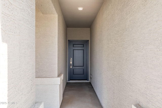 property entrance with stucco siding