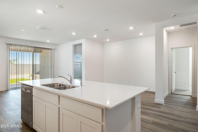 kitchen featuring recessed lighting, dark wood-style flooring, a sink, and dishwasher