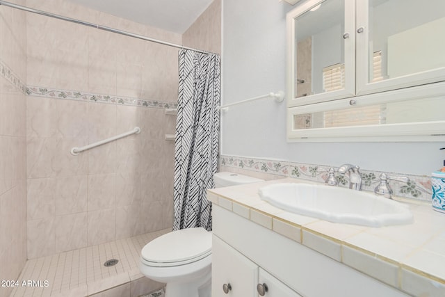 bathroom with curtained shower, vanity, and toilet