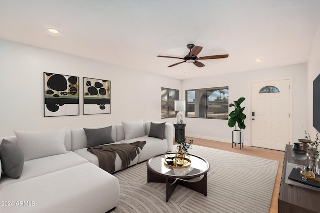 living room with ceiling fan and light hardwood / wood-style floors