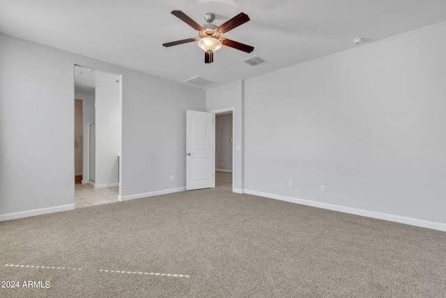 carpeted spare room featuring ceiling fan