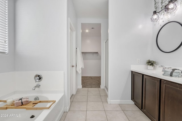 bathroom featuring tile patterned floors, a washtub, and vanity