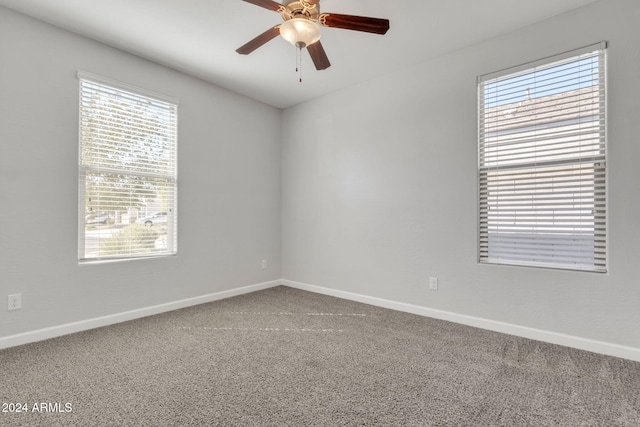 carpeted empty room featuring ceiling fan