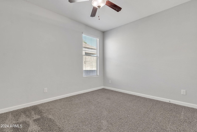 spare room with ceiling fan and carpet