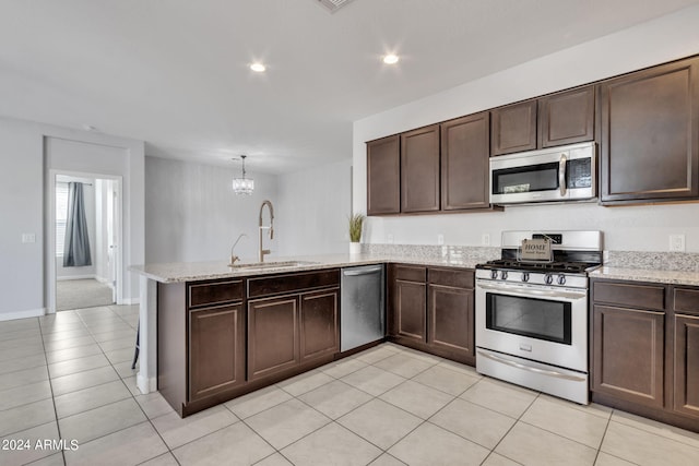 kitchen featuring dark brown cabinetry, sink, kitchen peninsula, hanging light fixtures, and appliances with stainless steel finishes