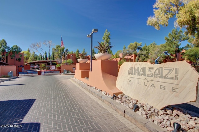 community sign featuring a gate