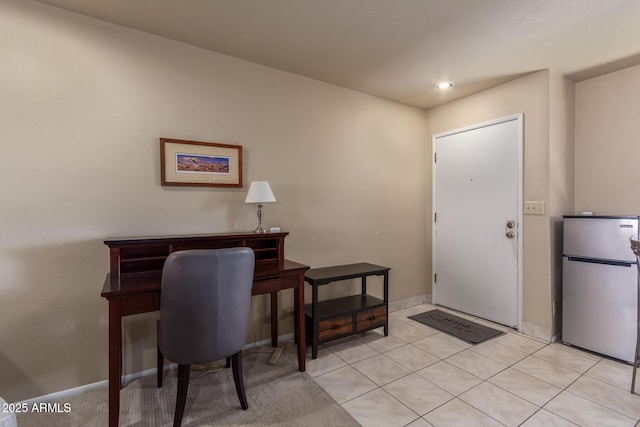 home office with light tile patterned flooring and baseboards