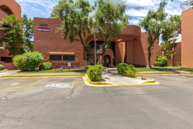 view of property featuring uncovered parking