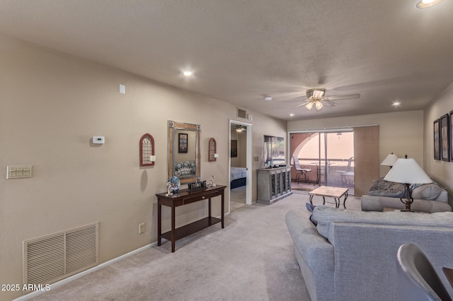 living area with recessed lighting, ceiling fan, visible vents, and light carpet