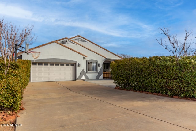 mediterranean / spanish-style home with a garage