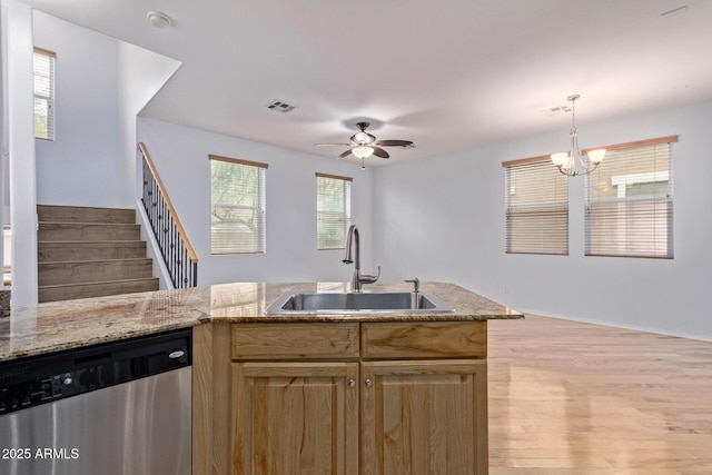 kitchen with sink, hanging light fixtures, light hardwood / wood-style floors, ceiling fan with notable chandelier, and stainless steel dishwasher