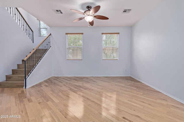 unfurnished living room featuring ceiling fan and light hardwood / wood-style floors