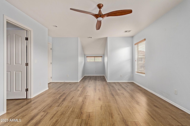 empty room with ceiling fan and light hardwood / wood-style flooring