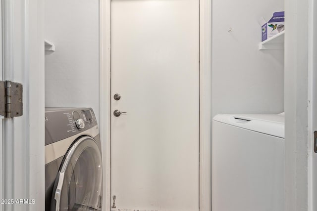 laundry room featuring washing machine and dryer