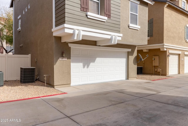 view of front facade with cooling unit and a garage