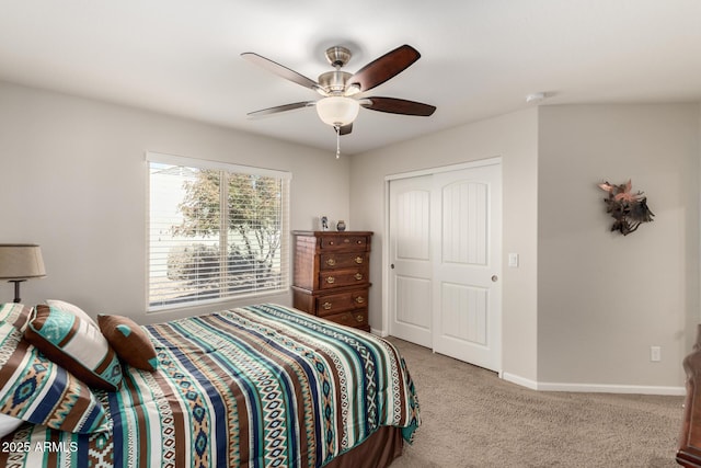 bedroom with ceiling fan, a closet, and light carpet