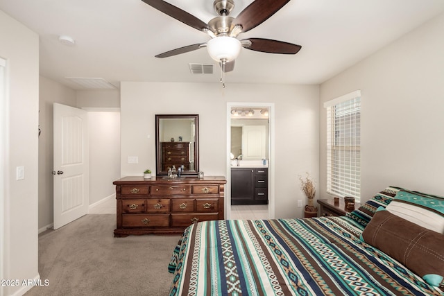 carpeted bedroom featuring ceiling fan and connected bathroom