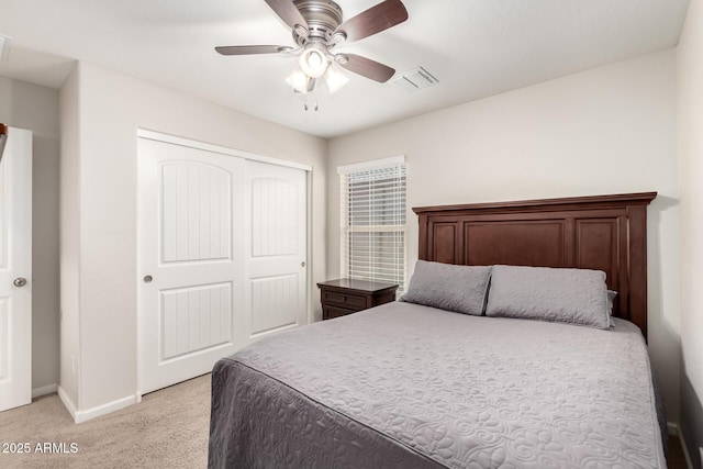 carpeted bedroom featuring ceiling fan and a closet