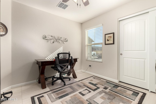 tiled office featuring ceiling fan