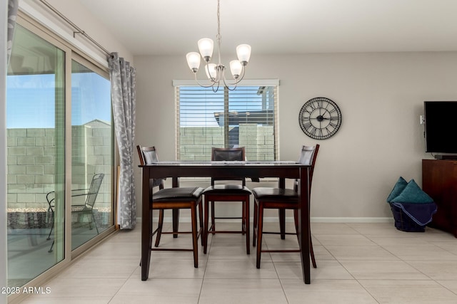 dining area with a chandelier and light tile patterned floors