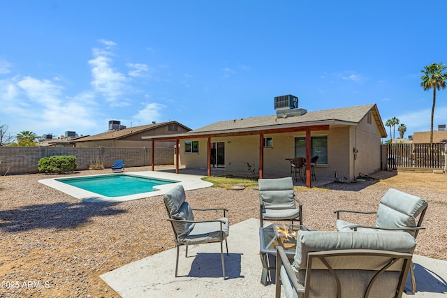 view of pool featuring a fenced backyard, a patio area, and central AC unit