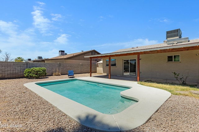 view of pool with a patio, a fenced backyard, and central AC unit