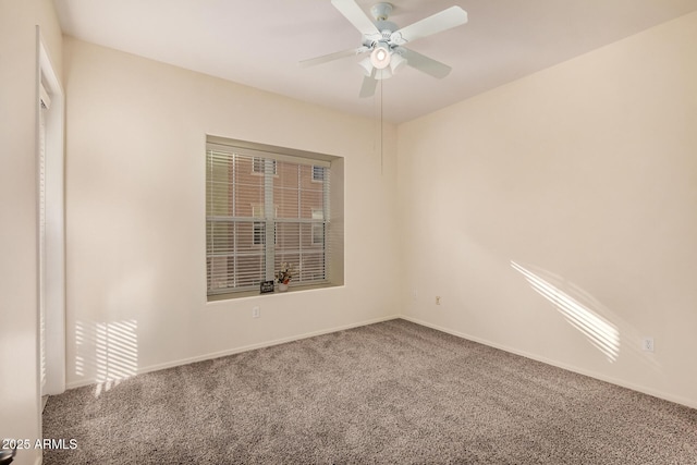 carpeted spare room with ceiling fan