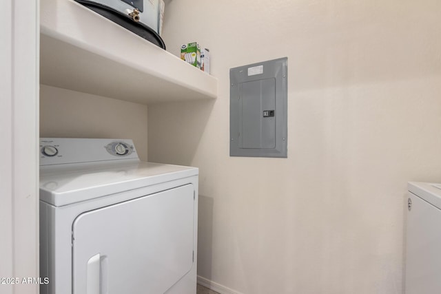 clothes washing area featuring washing machine and clothes dryer and electric panel