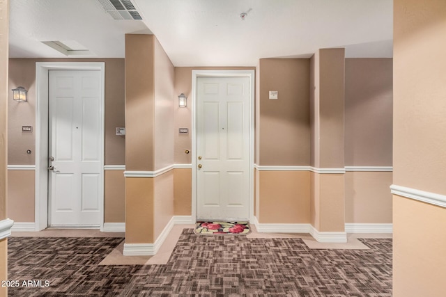 view of carpeted foyer entrance