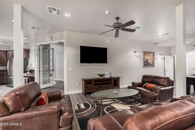 living room with hardwood / wood-style flooring and ceiling fan