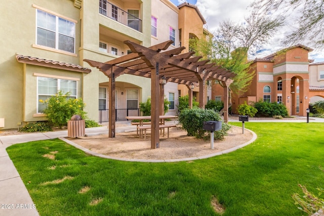 view of community featuring a pergola and a lawn