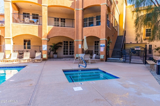 view of swimming pool with a community hot tub and a patio