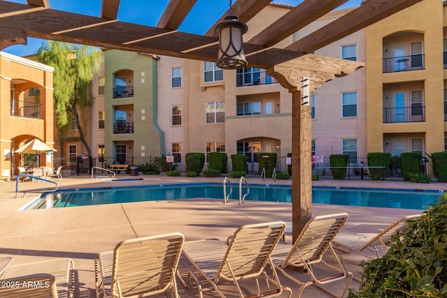 view of swimming pool featuring a pergola and a patio area